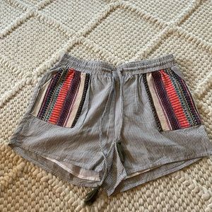 Grey and white striped shorts with multicolor woven pockets. Size small.